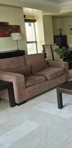 a large brown couch in a living room at SDQ apartamentos in Cancino