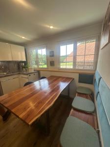 a kitchen with a wooden table in a room at Haus am Murgtalpfad 1 und 2 in Rickenbach