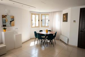 a kitchen and dining room with a table and chairs at Paez Villa - Private Pool - 3BR - Walk to Beach - Pernera Protaras in Protaras