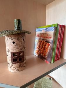 a shelf with a box of crackers and a book at Strandläufers Ruhe in Wiepkenhagen +8 photos