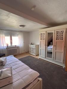 a bedroom with a large bed and a window at Strandläufers Ruhe in Wiepkenhagen