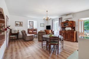 a living room with a table and a dining room at Maison De Campagne in Ligneyrac
