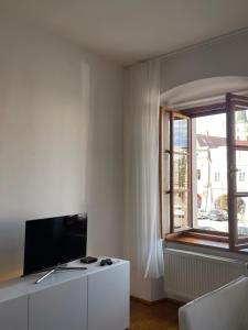 a living room with a tv and a window at Prázdninový dům Litomyšl 79 in Litomyšl