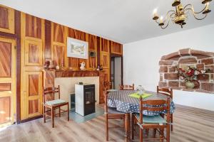 a living room with a table and a fireplace at Maison De Campagne in Ligneyrac