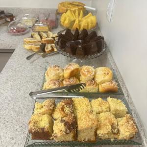 a table with a bunch of pastries and other desserts at Hotel Golden Palace in Fonte Termal Água Quente