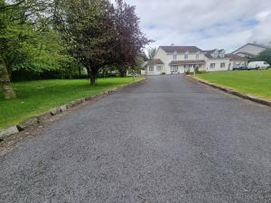 an empty road in front of some houses at Oyster Lodge shared accomadation in Galway