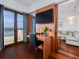 a living room with a desk and a couch at Porto Veneziano Hotel in Chania