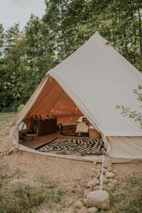a large tent with a bed in the middle at Szykidym in Hartowiec +26 photos