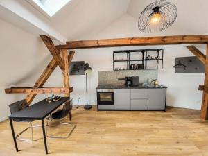 a kitchen with a table and a counter in a room at Ferienwohnung König in Brandenburg an der Havel
