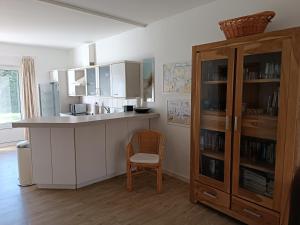a kitchen with a counter and a wooden cabinet at Haus am Prerow-Strand in Prerow