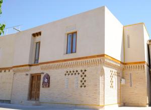 a building on the side of a street at Mashkobi Buxoro in Bukhara