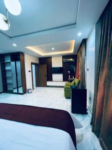 a bedroom with a bed and a living room at Soilsmart Haven in Abuja