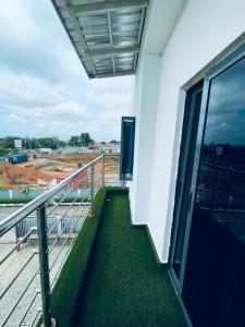 a balcony of a building with a view of a field at Soilsmart Haven in Abuja