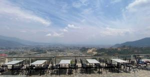 a group of tables and chairs on a balcony at Cherry villa in Manamaiju