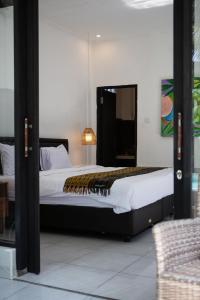 a bedroom with a bed with a tiger blanket on it at Parafrutts Apartments by Ateliero in Ubud