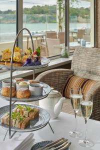 a table with plates of food and glasses of wine at L’Horizon Beach Hotel & Spa in St. Brelade