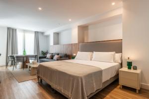 a bedroom with a bed and a living room at Cauce 4 Apartments in Torremolinos