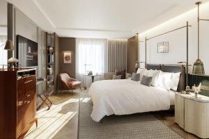 a hotel room with a large bed and a desk at The St. Regis London in London +28 photos
