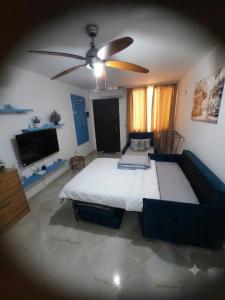 a bedroom with a large bed and a ceiling fan at Mimoza Appartament in Golem