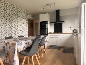 a kitchen and dining room with a table and chairs at La Maison du Bocage in Saint-Mesmin