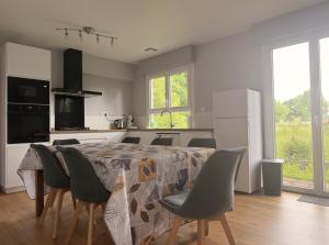 a kitchen with a table and chairs in a kitchen at La Maison du Bocage in Saint-Mesmin +1 photo