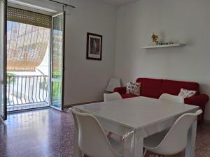 a living room with a white table and chairs at A due passi dal mare in Praia a Mare