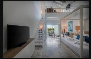 a living room with a flat screen tv in a room at Ocean Blue & Sand Beach Resort - All Inclusive in Punta Cana
