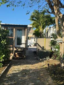 a house with a porch and a driveway at Beach Bum Bungalow in Jensen Beach