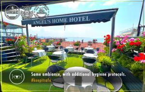a sign for anopheles home hotel with chairs and flowers at Angel's Home Hotel - Angel Group Hotels in Istanbul
