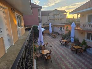 an outdoor patio with tables and chairs and umbrellas at La Camuflaj 2 Mai in 2 Mai