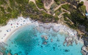 an aerial view of a beach with people on it at Marinella Retreat - Brezza in Zambrone +2 photos