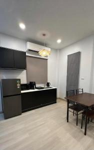 a kitchen and dining room with a table and a tableablish at The Summer Cozy Cottage in Haad Chao Phao