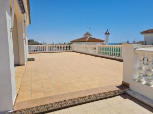 a balcony of a house with a white fence at Casa DOÑANA in Matalascañas
