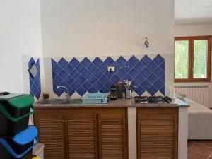 a kitchen with a sink and a counter top at Marinella Retreat - Sole in Zambrone +2 photos