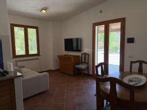 a living room with a couch and a table at Marinella Retreat - Sole in Zambrone