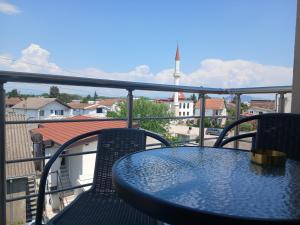 a blue table and chairs on a balcony at Noara Apartments Modern Stay Near Beach Free Parking Ideal for Families and Groups in Donji Štoj