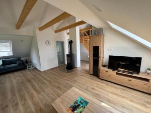 a living room with a large flat screen tv at Apartma Pr`mejač in Laze v Tuhinju