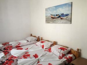 two twin beds in a room with a picture on the wall at Къща Йорданови in Chernomorets