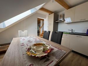 a table in a kitchen with a bowl on it at Apartma Pr`mejač in Laze v Tuhinju