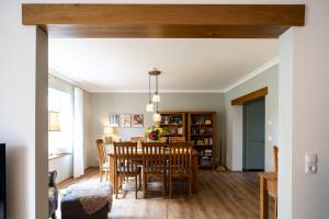 a dining room and living room with a table and chairs at Ferienhaus-WalnutCottage in Rechlin