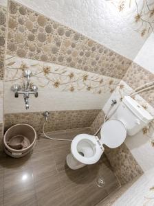 a bathroom with a toilet and a sink at hotel shree guru pandey in Indore