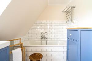a bathroom with a bath tub in a attic at Ferienhaus-WalnutCottage in Rechlin +81 photos