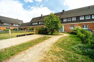 a brick building with a tree in front of it at Ferienhaus-WalnutCottage in Rechlin