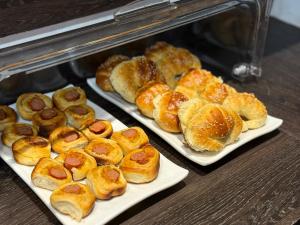 two trays of pastries on plates in an oven at Hotel Ciudad Nueva in Ciudad del Este +31 photos