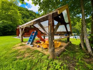 a childrens play area with a slide and a playground at Camping La Lienne in Stoumont +30 photos