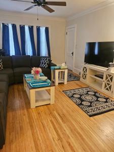a living room with a couch and a flat screen tv at Plantlife LLC A in Minneapolis