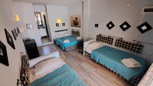 a room with two beds and a television in it at Hotel Idea in Fourka +62 photos