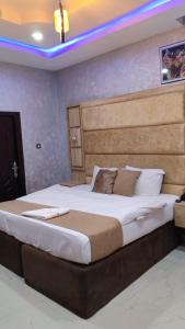 a bedroom with a large bed in a room at Indian Atlantic Hotel & Suites in Agbor