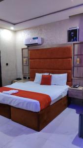 a bedroom with a large bed in a room at Indian Atlantic Hotel & Suites in Agbor