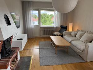 a living room with a couch and a table at Hardangegatan in Östersund